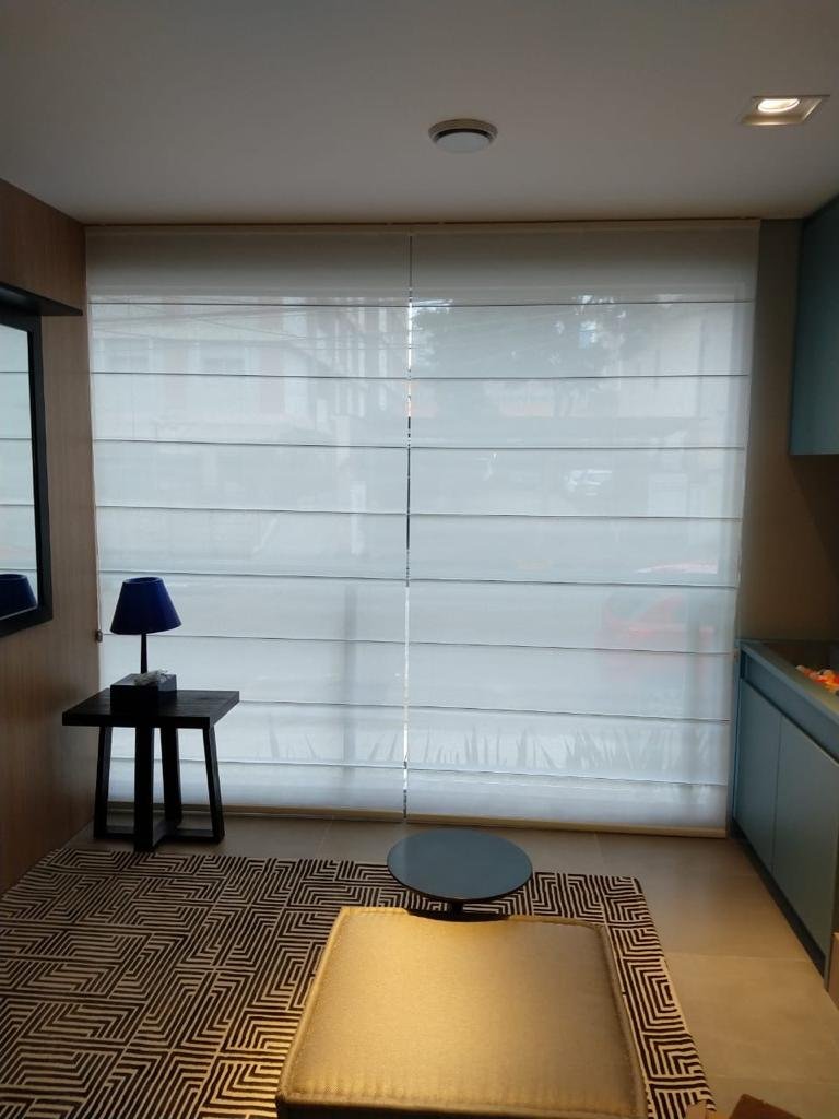 Roman shade in a living area with dark furniture