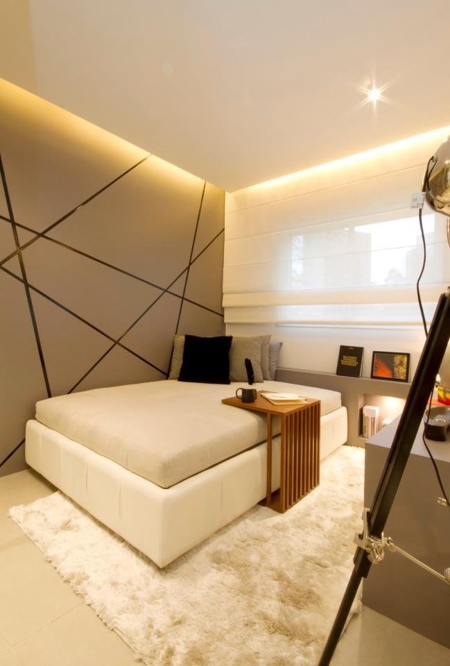 Roman shade in a modern bedroom with a geometric accent wall