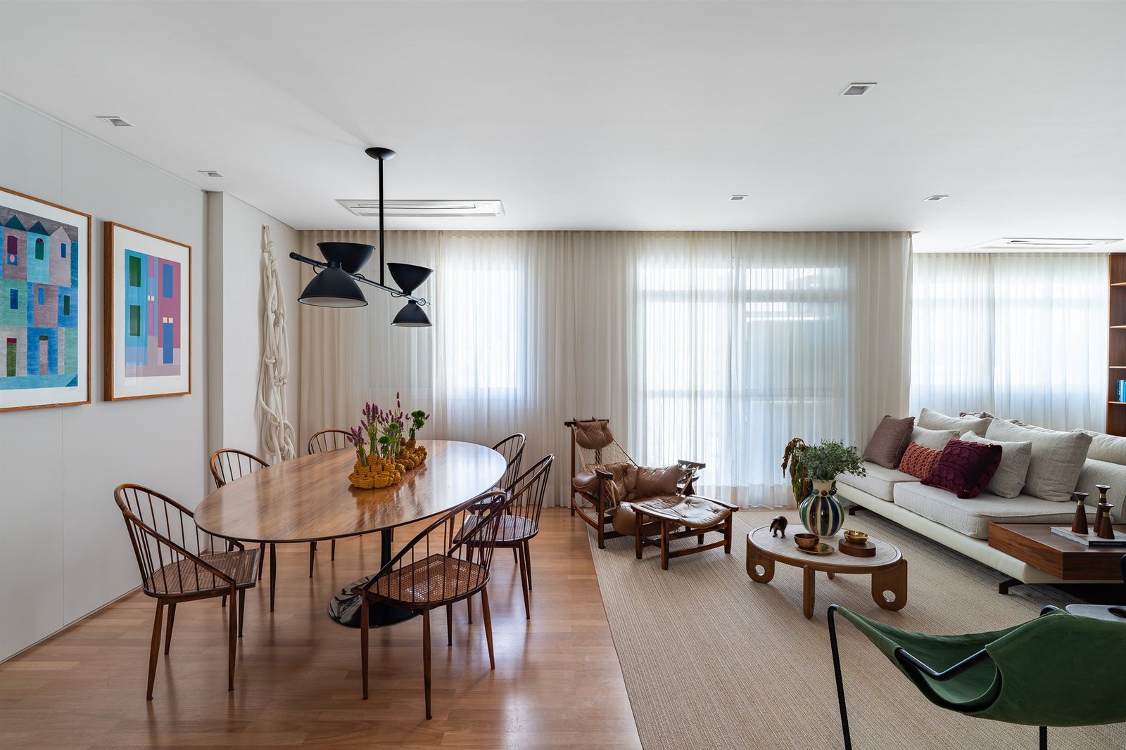 Sheer curtains across a dining and living room