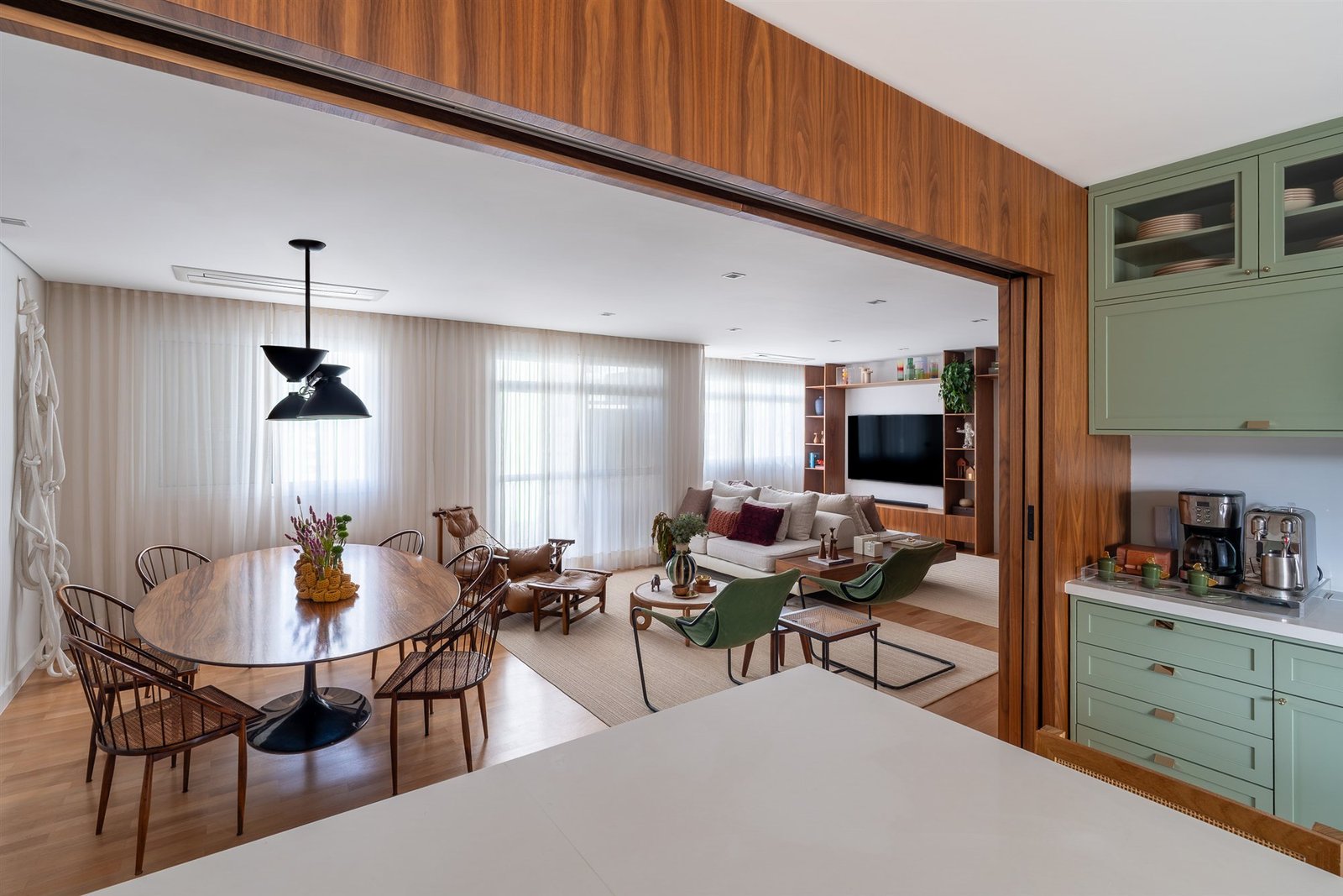 Dining area with sheer curtains seen through a wide opening